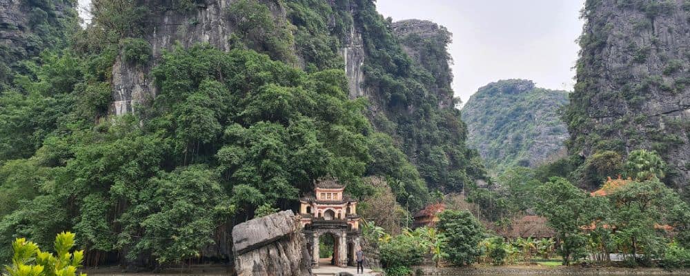 tall rock formations and a pergoda. 