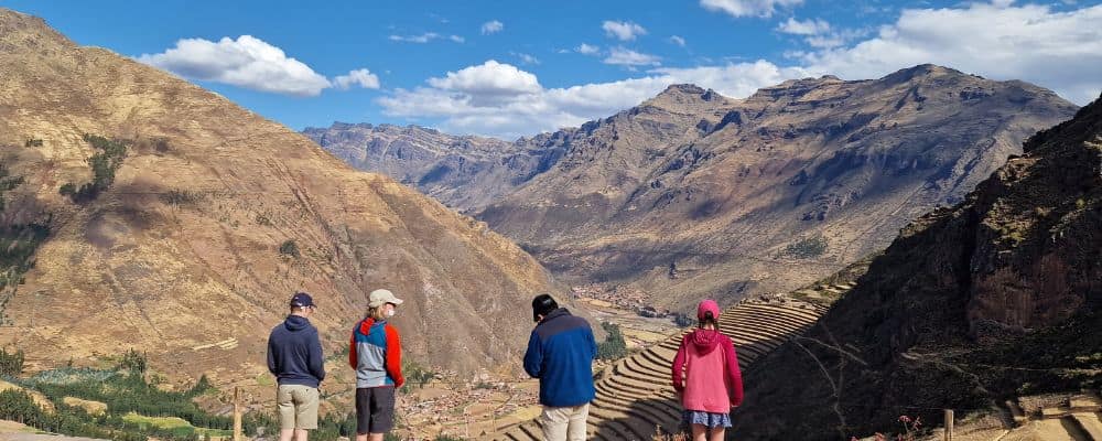 Kids looking out over Terraces and mountains in Sacred Valley, Peru with kids