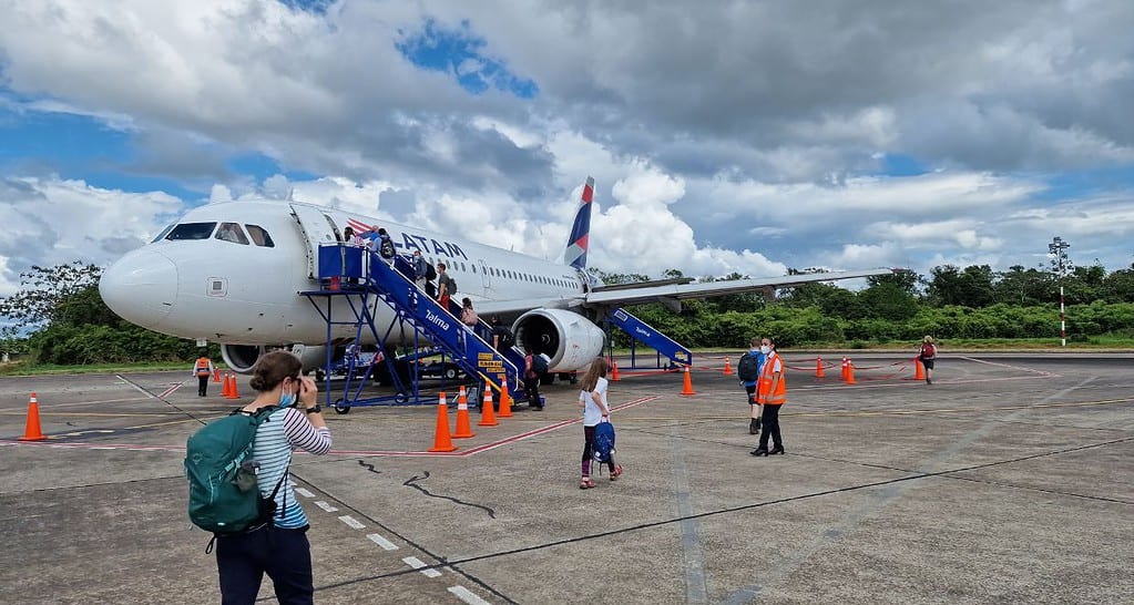A family boarding a flight from the runway when travelling in South America.