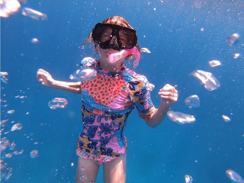 One of our kids enjoying snorkelling in the Philippines. Wearing a swim vest to protect against the sun.