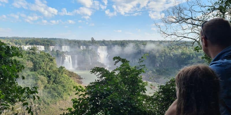 A family watching cascading waterfall from a distance. Iguazu Falls on the Brazilian side is fantastic when in Brazil with kids