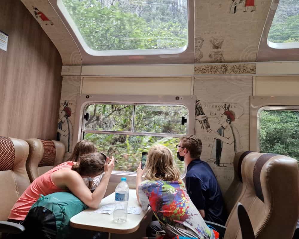 Scenic tourist train from Aguas Calientes back to Cusco after trekking the Inca Trail with kids