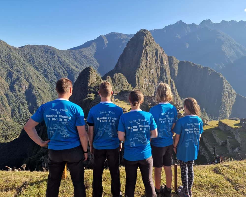 Trekking the Dream family at the lookout over the citadel at Machu Picchu Peru. Demonstrating you can trek the Inca Trail with kids.