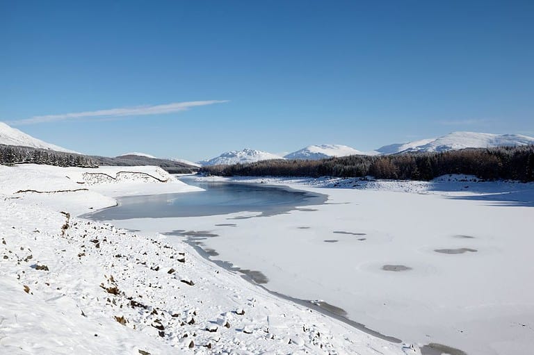 Loch Spean with Cairngorm mountains, ice and snow, Scotland by Elgol from Getty Images Signature