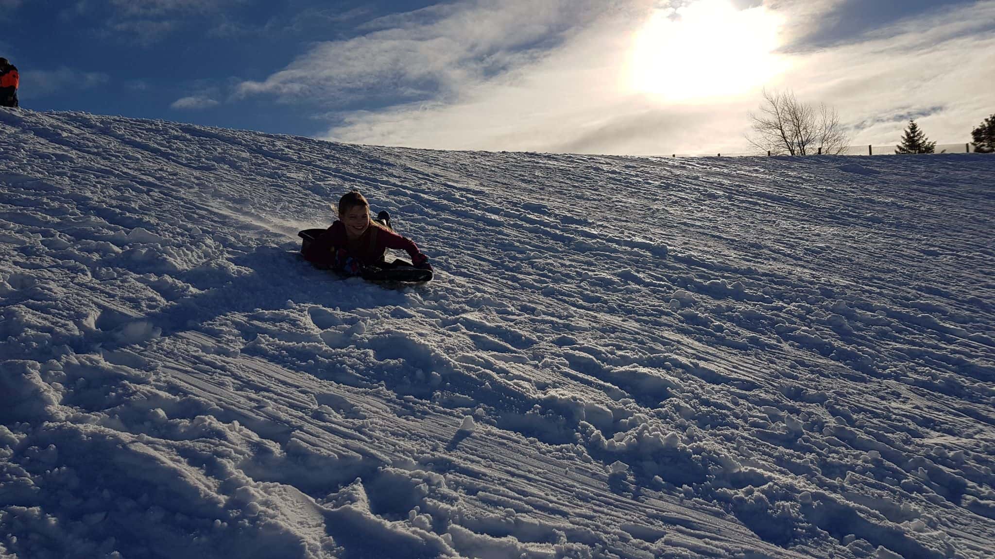 Sledging down a snowy hill in Scotland