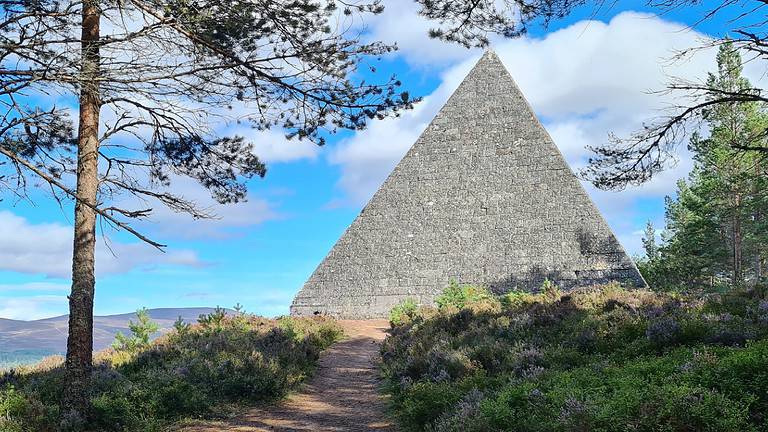 A Stone pyramid in Scotland surrounded by countryside.