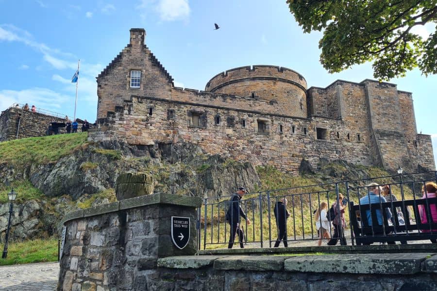 Edinburgh castle with people walking around the grounds