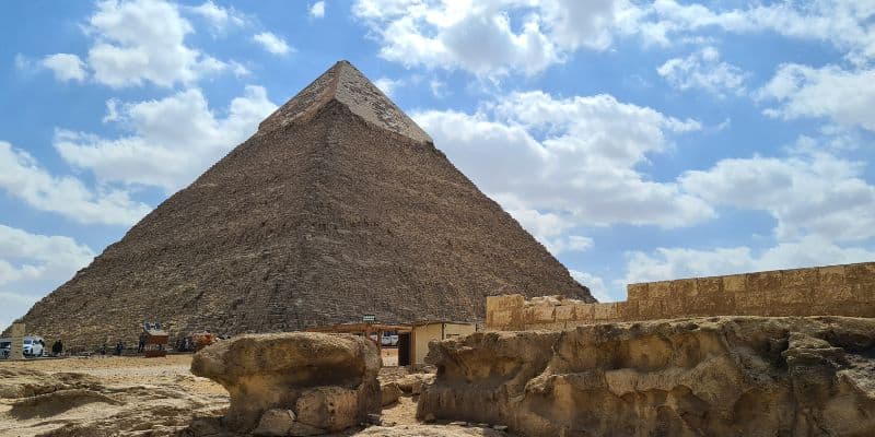 A pyramid in a desert with blue skies and clouds in Egypt perfect as a family road trip idea