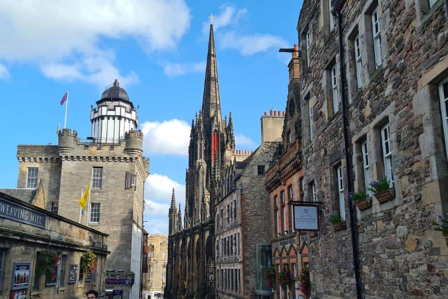 A view down the cobbled Royal Mile in Edinburgh, lined with buildings.