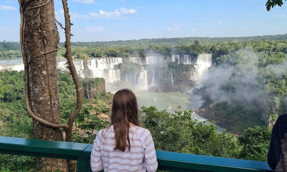 A kid visiting the best falls in South American rainforest 
