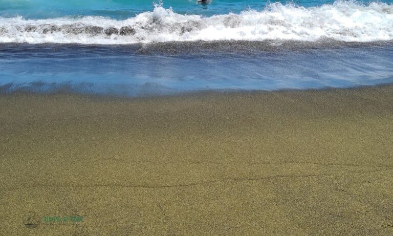 Green sand meets the ocean wave at Papakolea beach. A great stop on any Big Island itinerary.