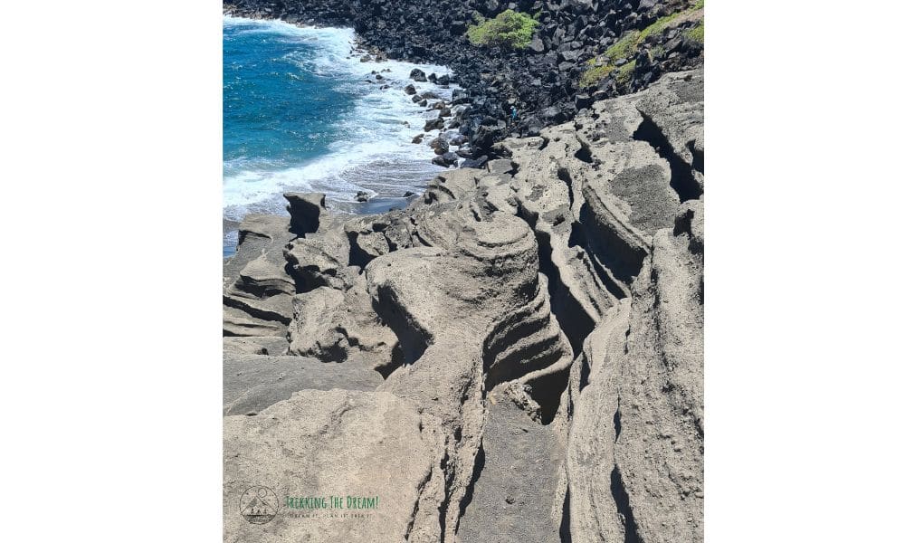 Volcanic rock formation with ocean.