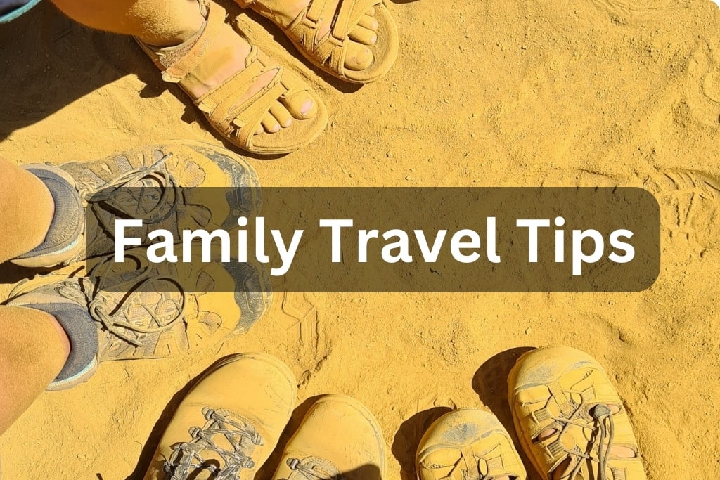 Family travel tips with a family trekking through sand.