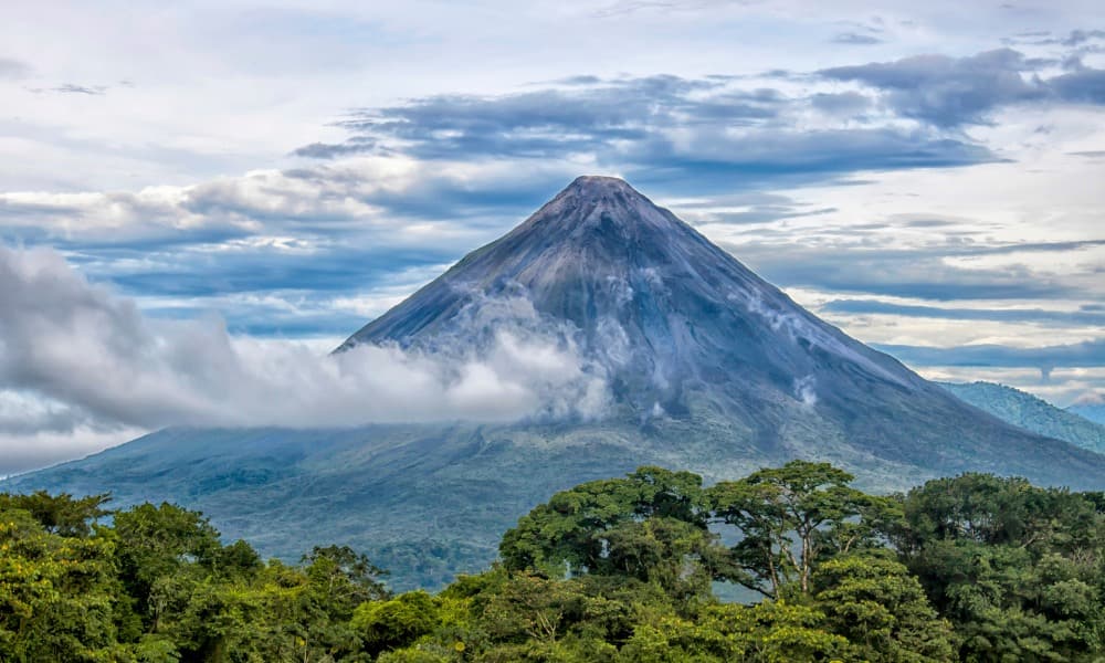 Volcano surrounded by rainforest and cloud in Costa Rica