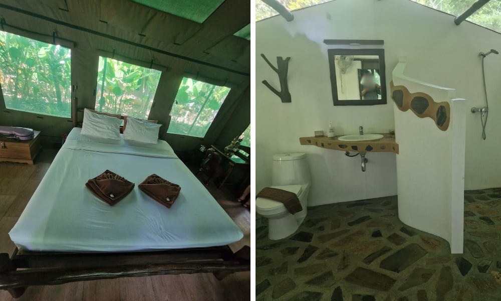 A bed with while sheets in a green tent and shower room with toilet.