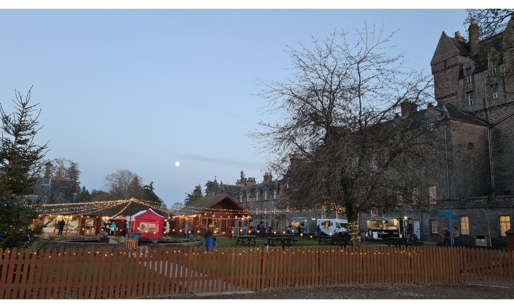 Gardens lit up with christmas tree and lights in the gardens of Glamis Castle 