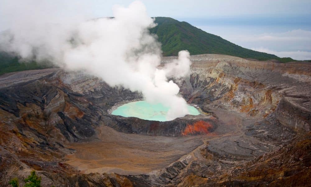 An active volcano producing a white cloud of steam 