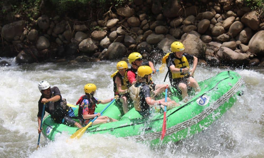 A family white water rafting on a river in Costa Rica.