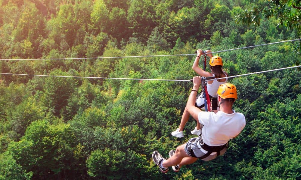 A family ziplining over a rainforest