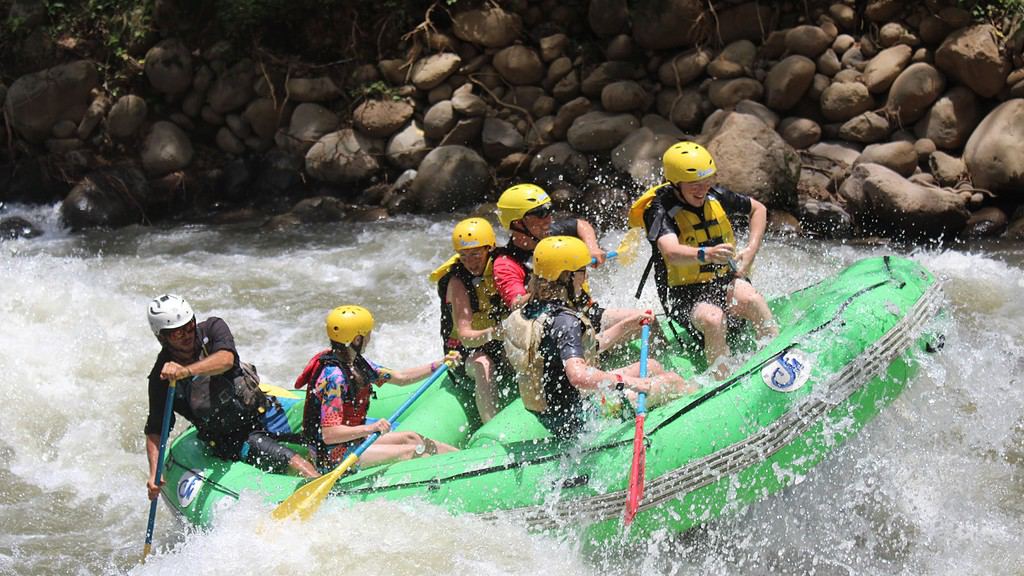 Family white water rafting on a river in Costa Rica the home to adrenaline activities.