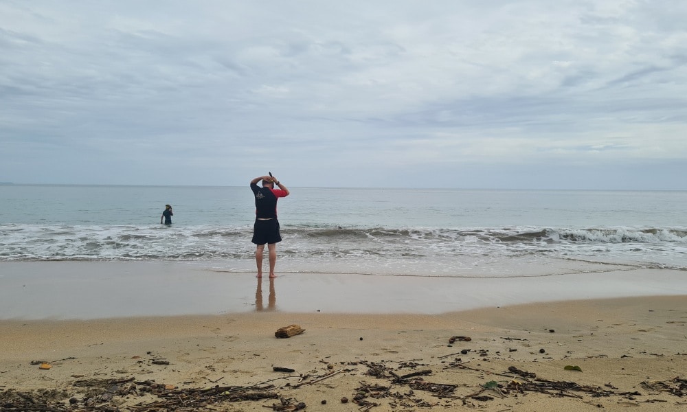 Family stood at the edge of the ocean to go snorkeling