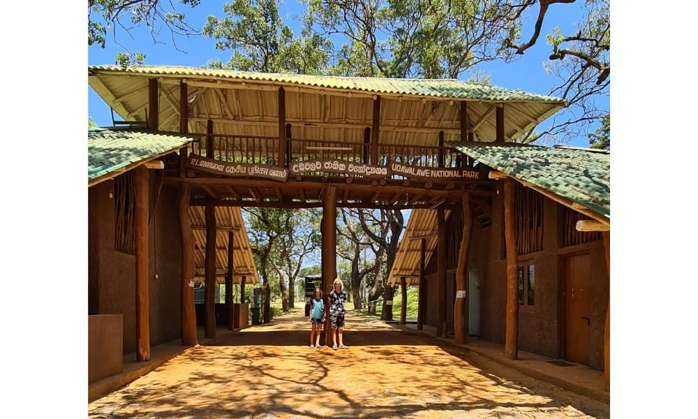  Kids stood at a safari entrance with blue sky in Sri Lanka 