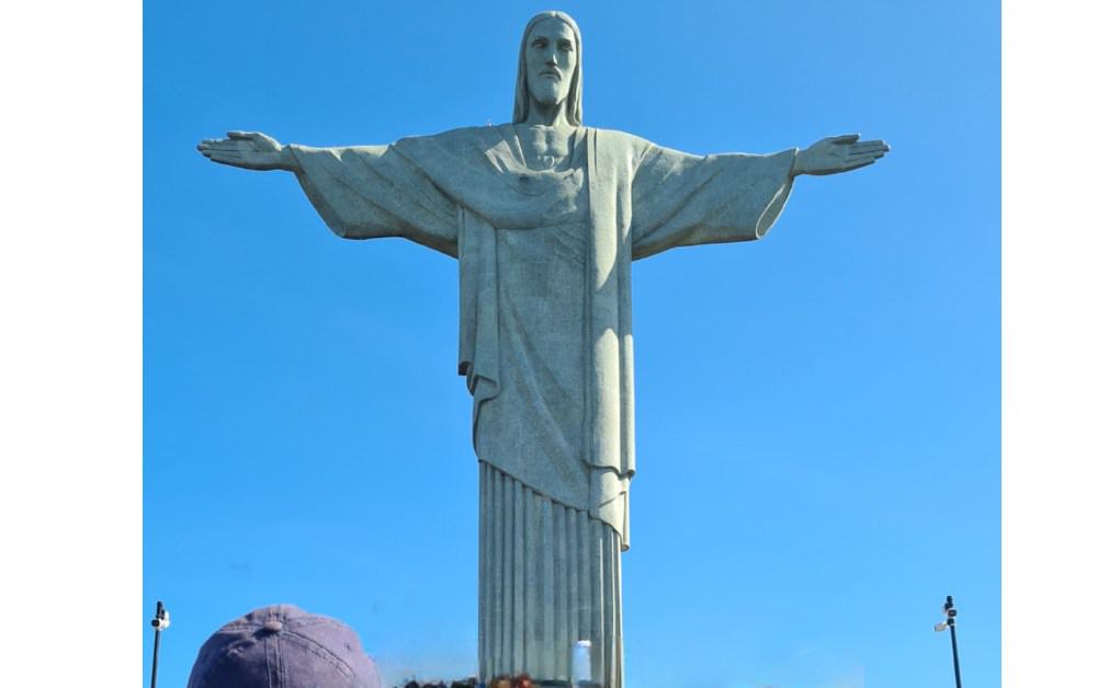 Tall iconic statue on a hill in Rio de Janeiro, a must see 8 wonder of the world.