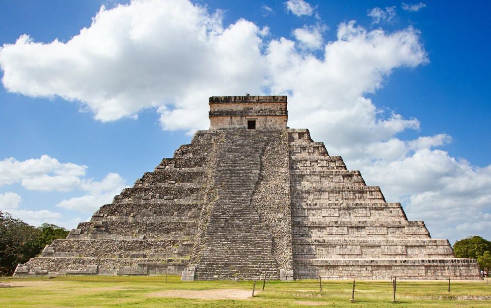 Large stone stepped pyramid on grass. One of the 8 wonders of the world.