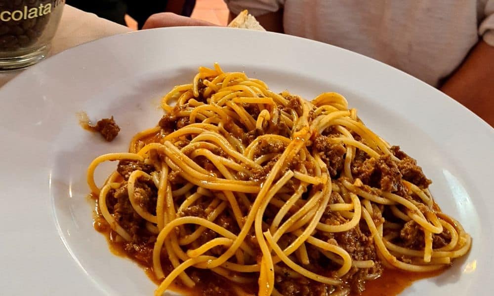 White  full of spaghetti and tomato sauce. Pasta is a top Italian food that kids love.