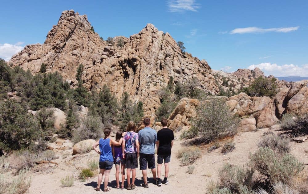 Trekking The Dream Family stood together in a rocky desert in USA