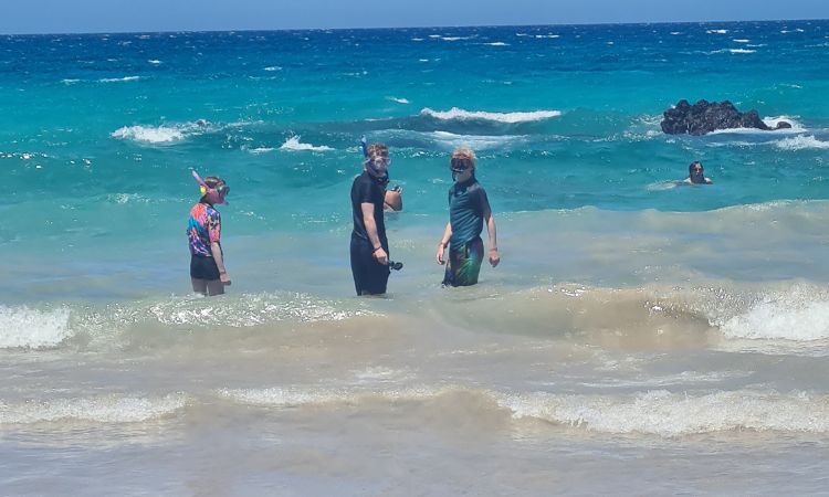 Kids snorkelling at a beach.