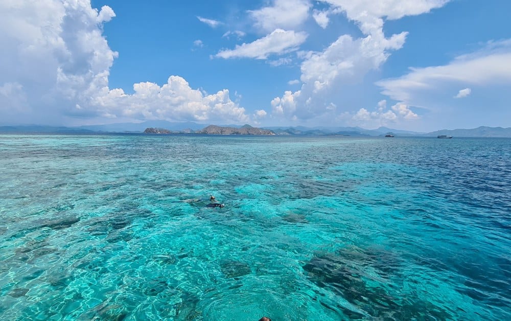 Clear turquoise sea with distant islands typical of Indonesia's Komodo National Park.