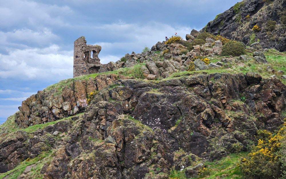 A stone ruin sat on a rocky hill in Holyrood Park Edinburgh.