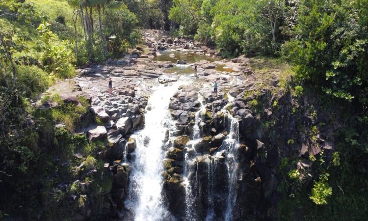 Trekking the Dream Family stood on top of a large waterfall in Big Island, Hawaii.