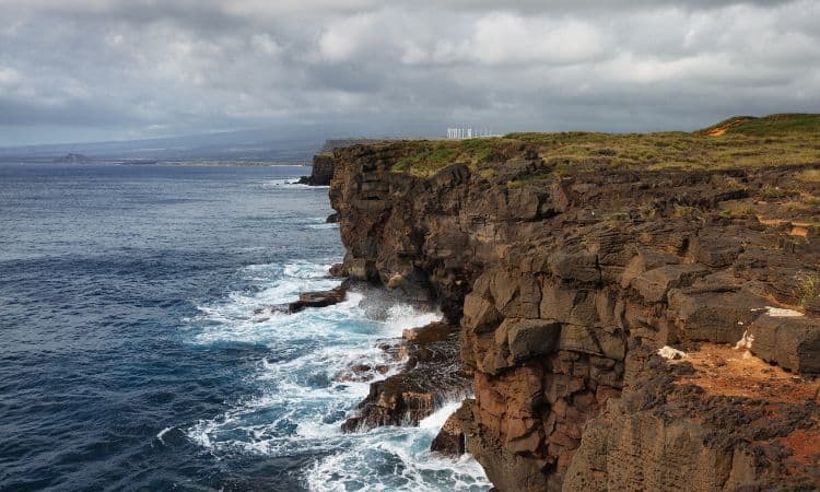 Rocky cliffs over ocean at the most southern point of Hawaii. This is a great point of interest on a Big Island itinerary. 