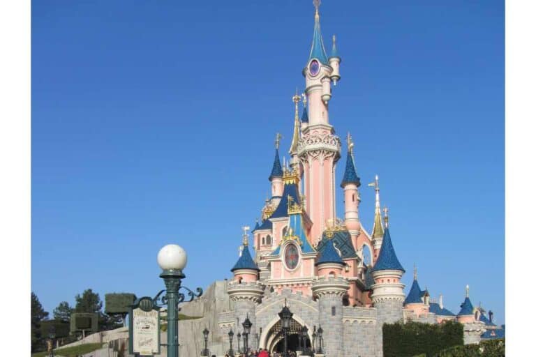 Fairy-tale pink castle at an amusement park. Disneyland Paris on a budget for families.