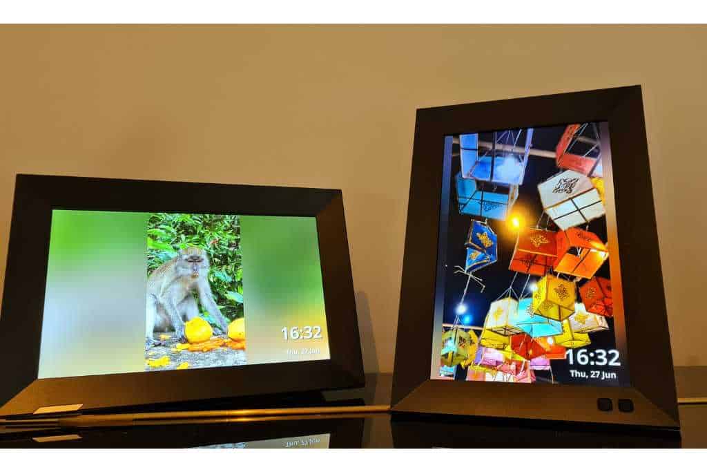 2 digital photo frames displaying travel photos.