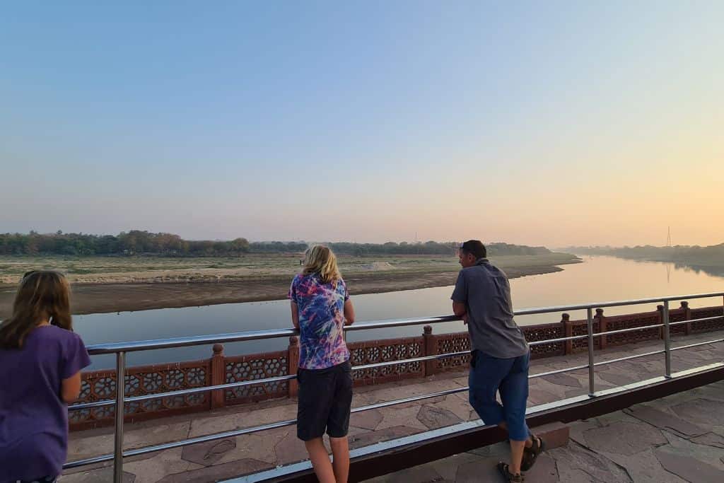 Trekking the Dream family looking out over a river at sunrise. 