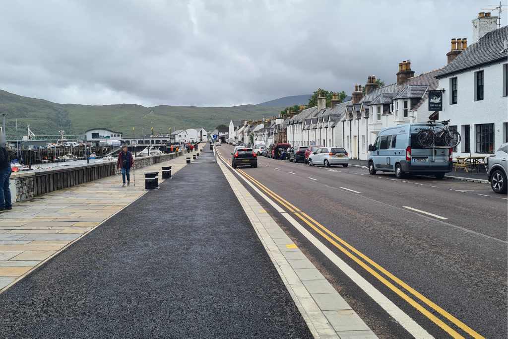 Road and path through a tourist town in Scotland.