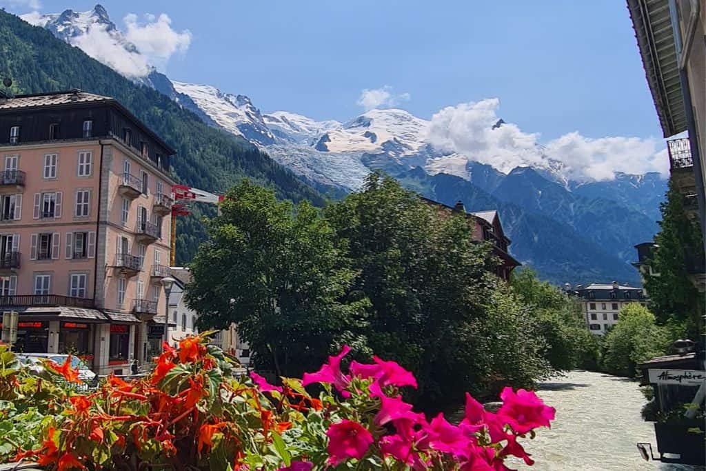 Mountain ski resort surrounded by glacial river and mountains.