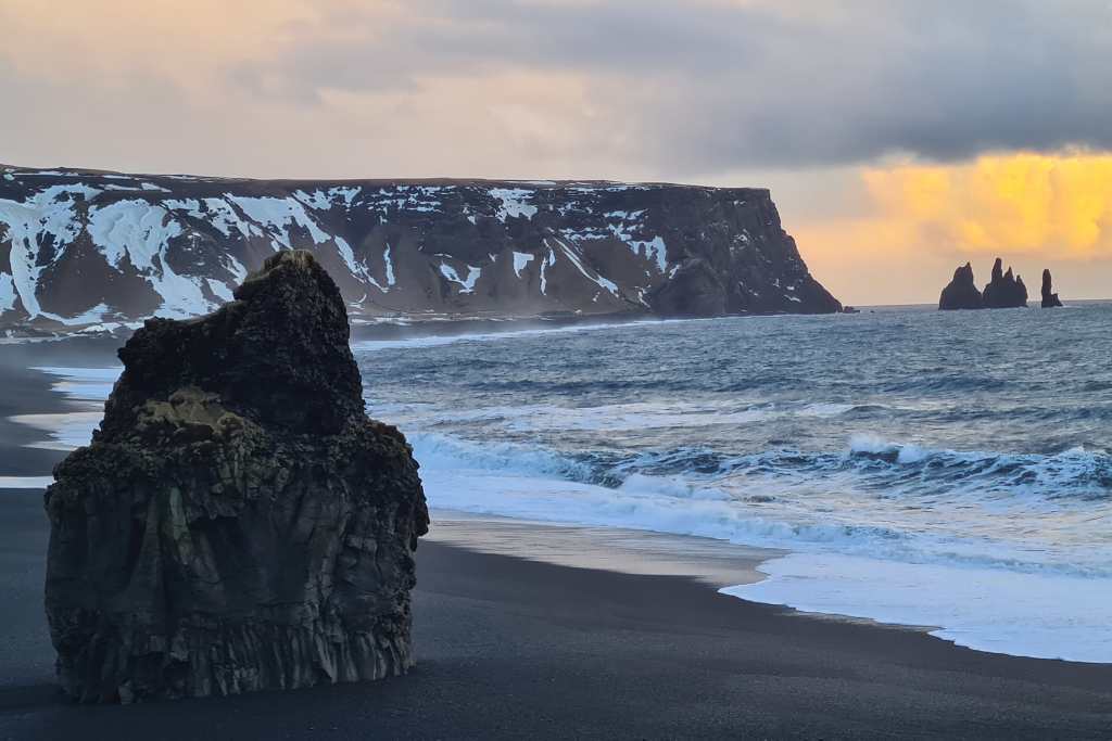 Iconic rock stacks on a black sand beach with a ferocious sea. A reason to visit South Iceland.