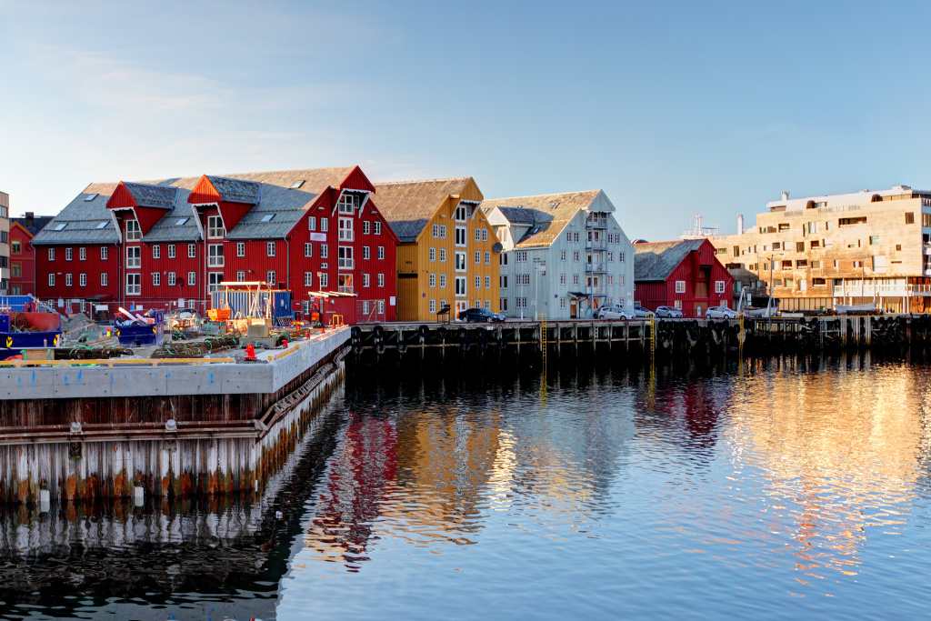 Colourful houses reflecting on water in winter.