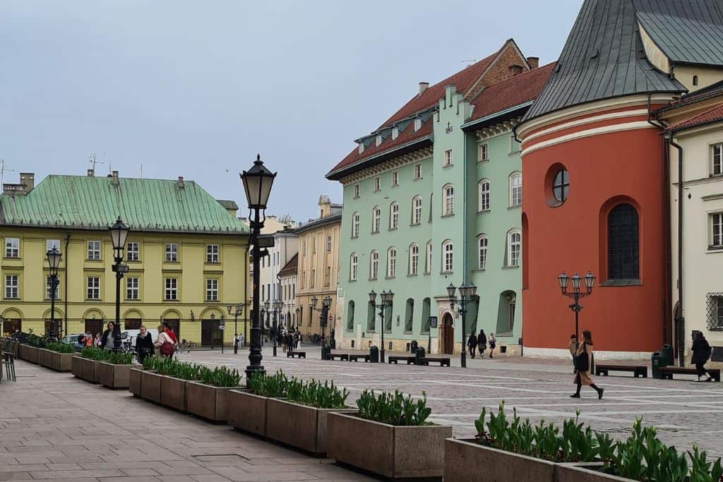 Colourful buildings around a town square in Europe.