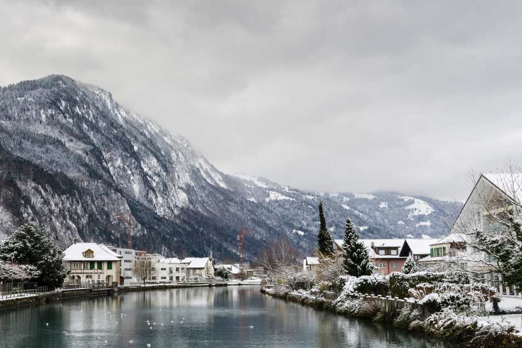 Snowy mountain and lake view. A typical view of the Alps in Winter.