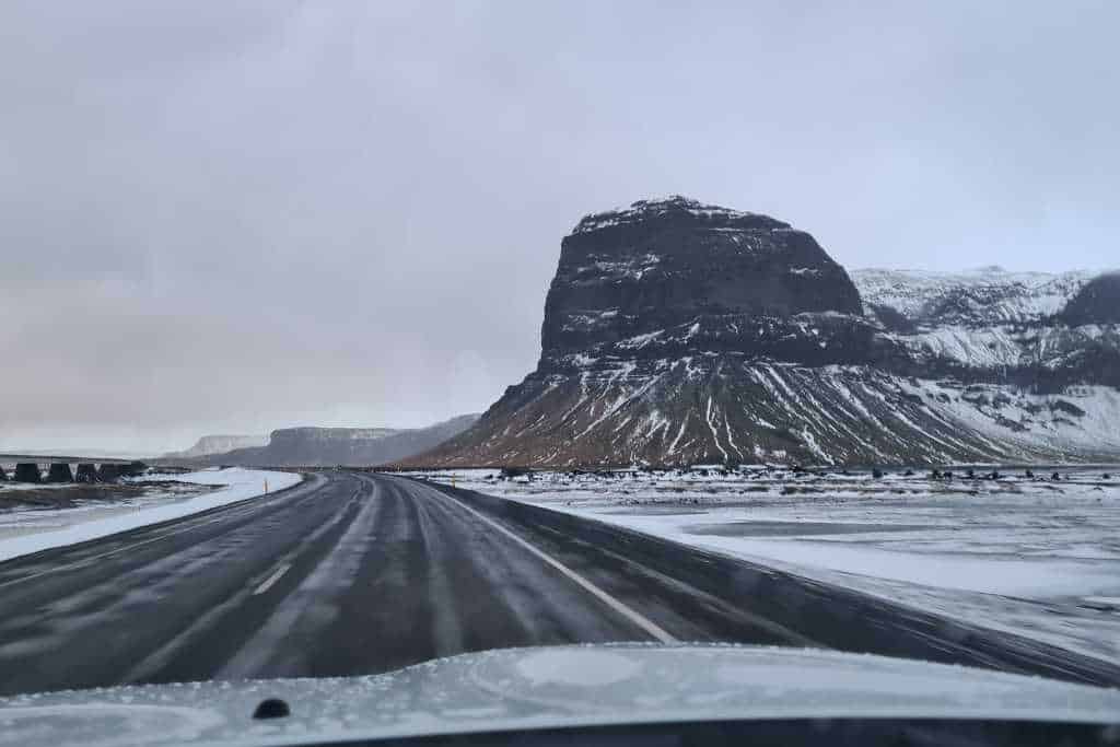 Snowy landscape with a volcanic mound.