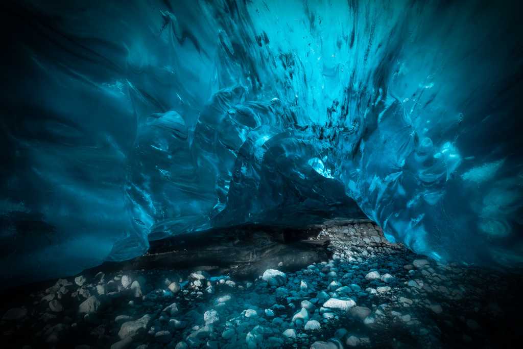 Blue ice cave with pebble floor