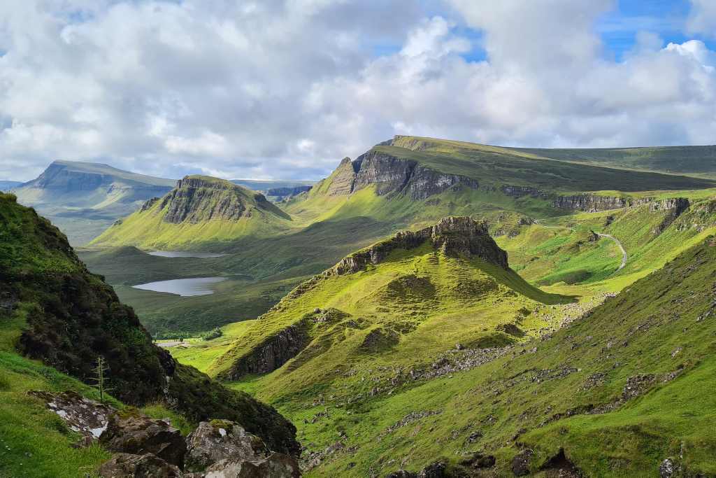 Magestic green hills jutting out at different angels on the Isle of Skye. A popular place To visit in Scotland.