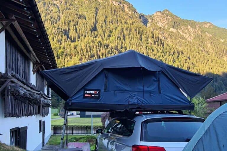 Rooftop tent on a car in the Austrian Alps. TentBox XL is great for families on a road trip.