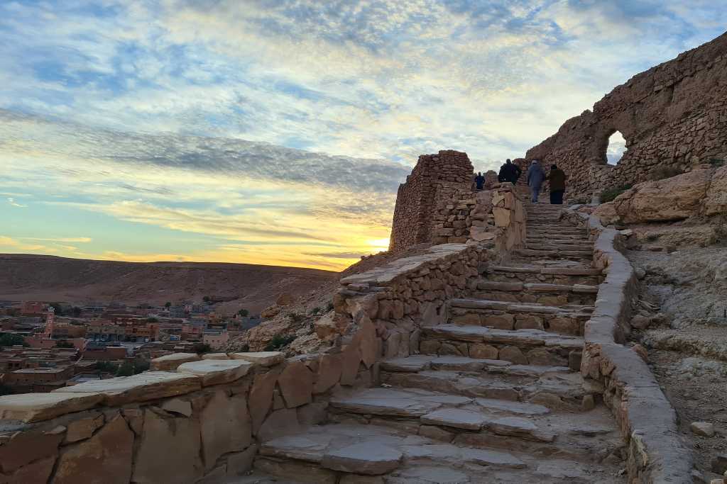 Stone steps leading up a hill at sunset. Ait Ben Haddou continues to be a popular stop for families from Marrakesh.