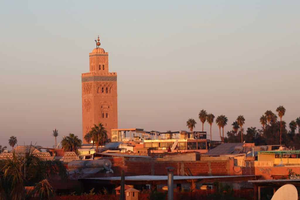 A city scape with a mosque at sunset in Morocco. Marrakesh is a popular place to visit with kids.